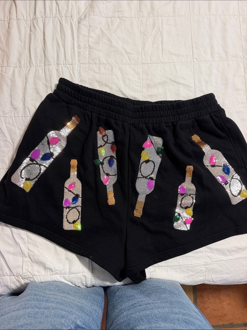 QUEEN OF SPARKLES Black Sequin Bottle Appliqué Athletic Shorts